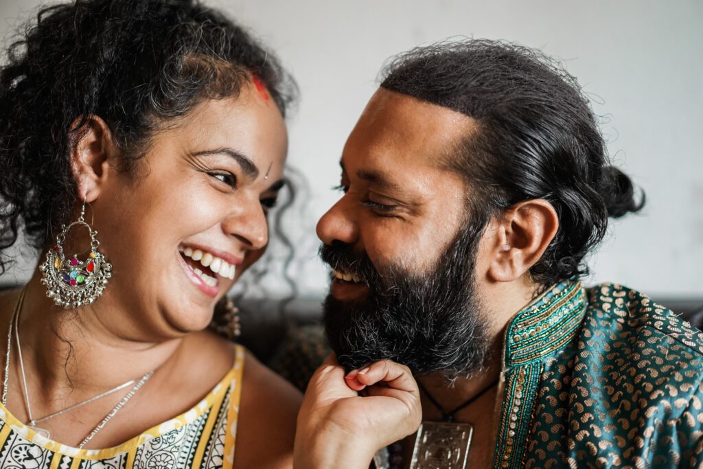 Indian couple having tender moments together indoors at home - Focus on woman face