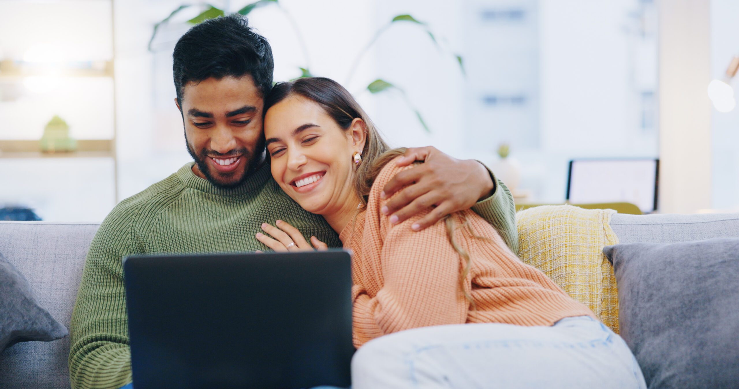 Couple, love and smile with laptop for online couples therapy